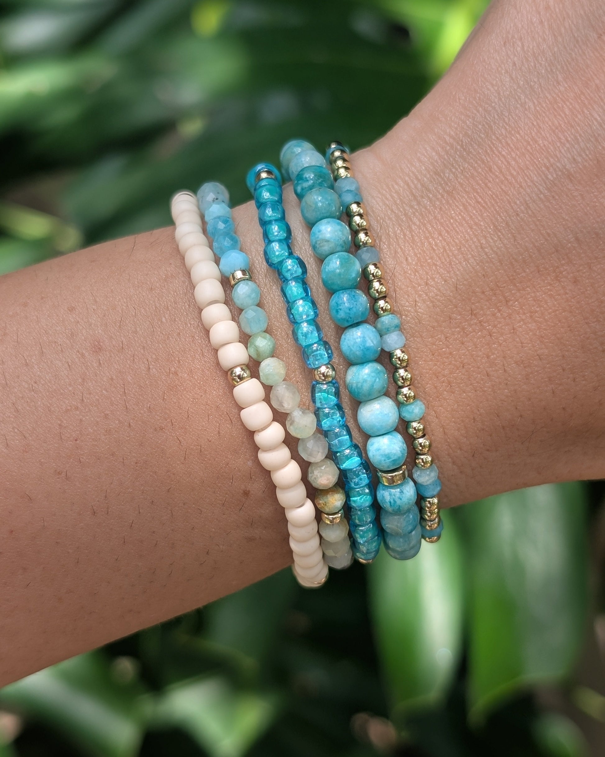Azure Sands coastal bracelet stack worn on the wrist featuring amazonite gemstones, turquoise beads, and gold-filled accents.