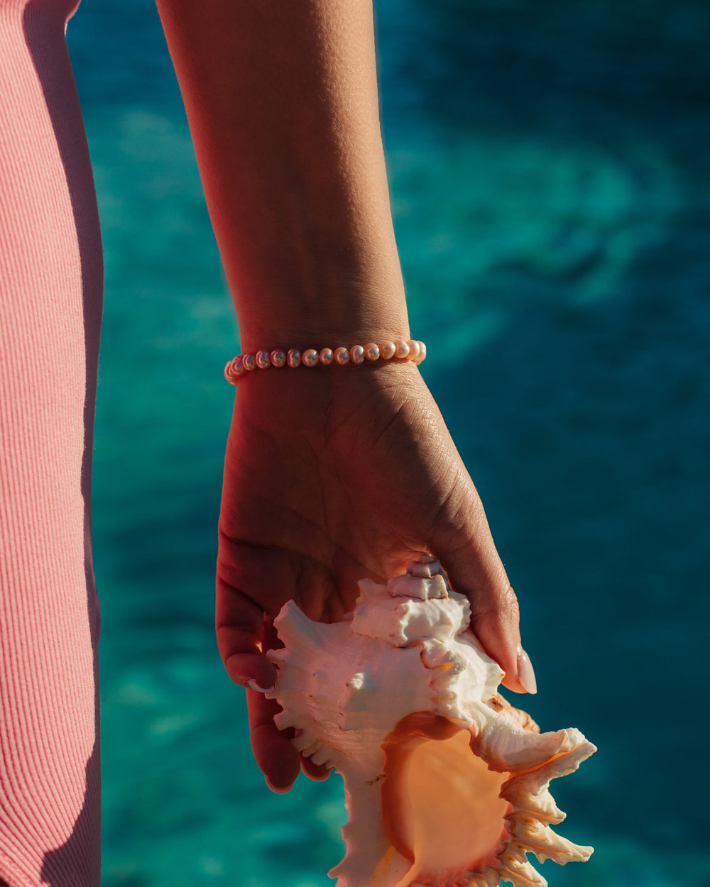 Close-up of the blush pink freshwater pearls and 18k Gold PVD accents