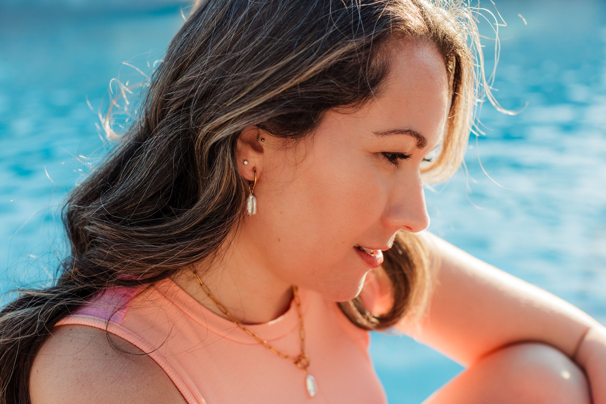 Rosé Resort Earrings worn – minimalist pink pearl huggie earrings from Charlotte’s Cove.