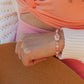 Pink Sands Bracelet layered with gold jewelry – Charlotte’s Cove Island Dreams Collection.