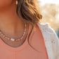 Pink Sands Necklace layered with gold chains – Charlotte’s Cove Island Dreams Collection.