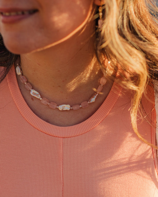 Pink Skies pink gemstone and baroque pearl necklace styled at the neckline