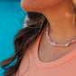 Pink Skies Necklace layered with gold chains – Charlotte’s Cove Island Dreams Collection.