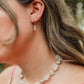 Salt Air Pearl Earrings featuring genuine freshwater pearl drops suspended from petite 18K gold PVD hoop earrings for timeless everyday coastal elegance.