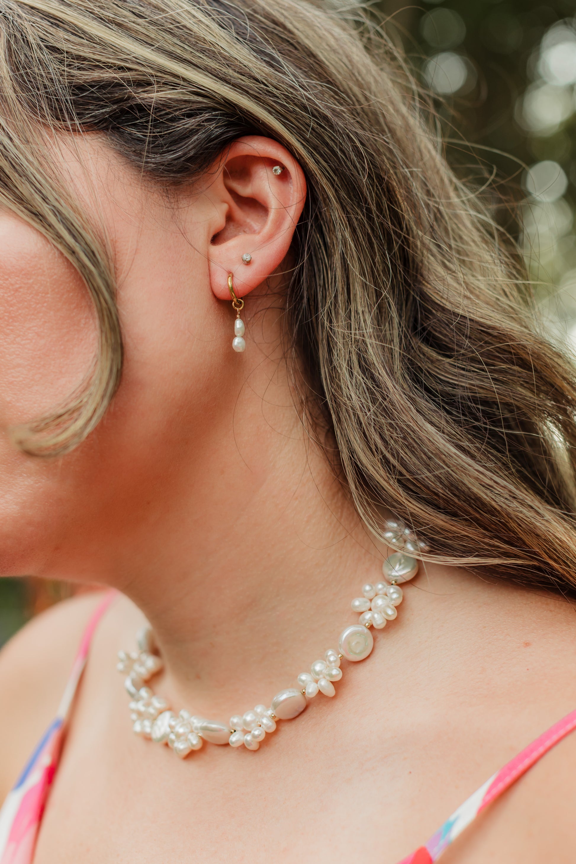 Salt Air Pearl Earrings featuring genuine freshwater pearl drops suspended from petite 18K gold PVD hoop earrings for timeless everyday coastal elegance.