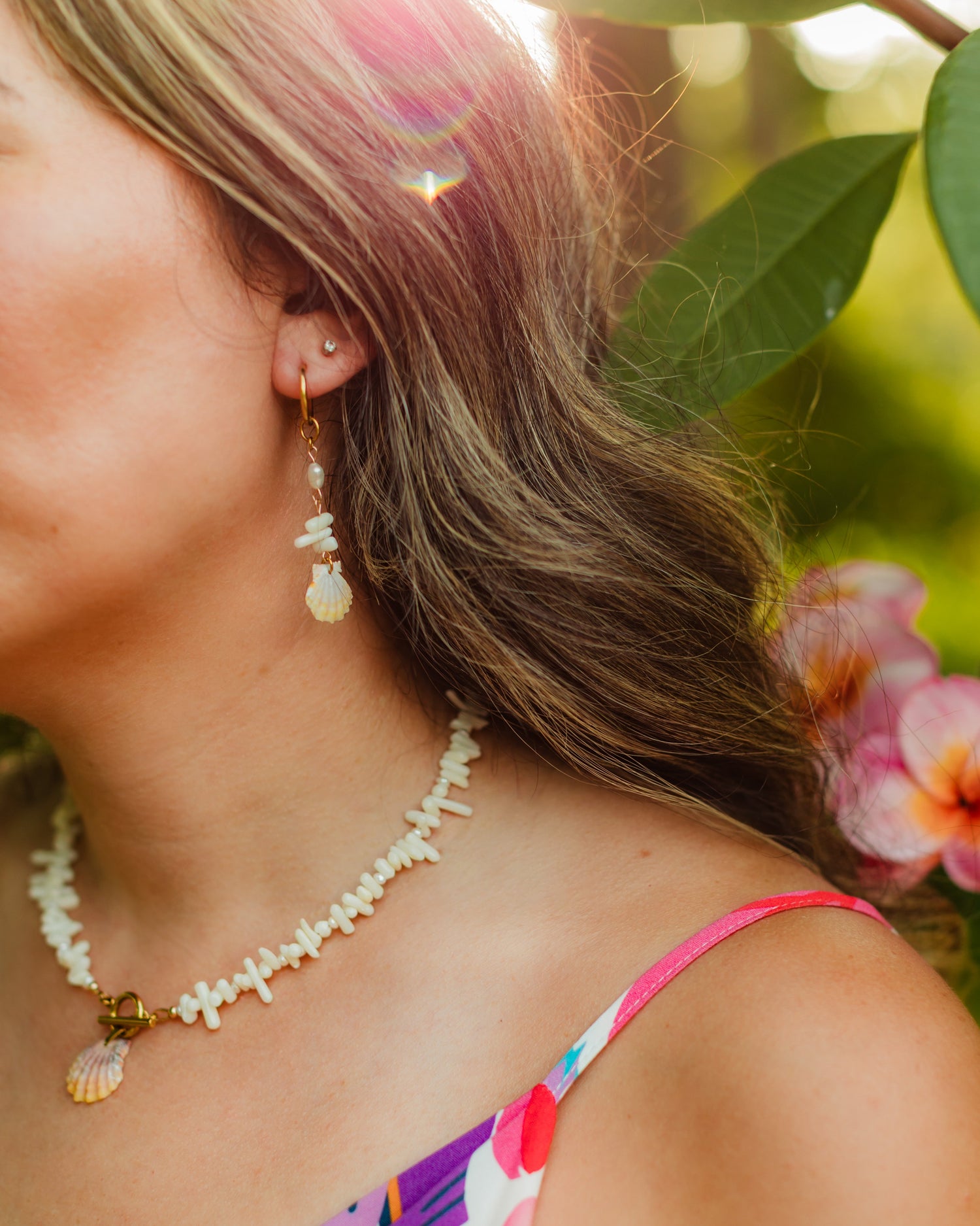 Sunrise Shell Earrings displayed with the coordinating Hawaiian sunrise shell, coral, and freshwater pearl necklace