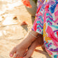 Woman wearing the Pearl Tide white freshwater pearl anklet with 18k Gold PVD hardware