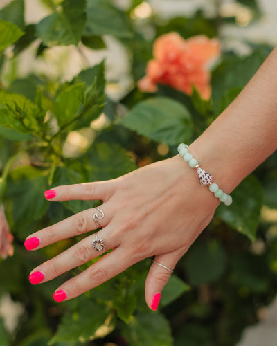Seafoam Cove green quartz and Hebrew cone shell bracelet styled in a serene coastal jewelry look