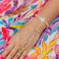 Honu Pearl Bracelet featuring genuine round freshwater pearls, polished 18K gold PVD spacer beads, and a hand-carved mother of pearl sea turtle centerpiece inspired by the treasured sea turtles of Hawaii.