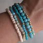 Close-up of the Azure Sands amazonite bracelet stack layered together with turquoise gemstones, seed beads, and 14K gold-filled accents.