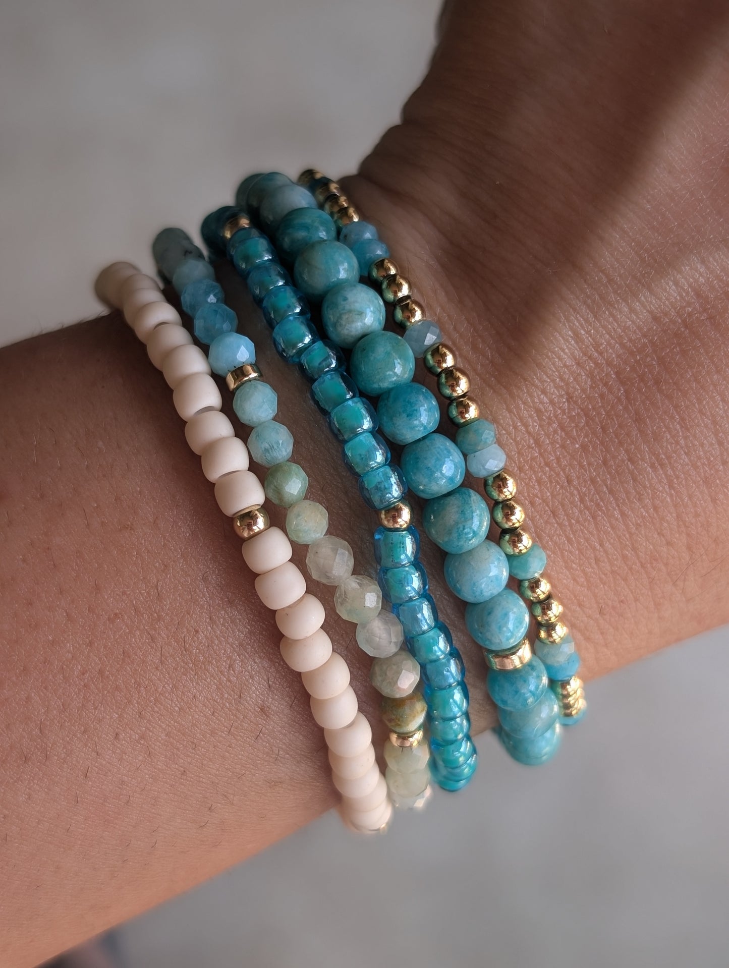 Close-up of the Azure Sands amazonite bracelet stack layered together with turquoise gemstones, seed beads, and 14K gold-filled accents.