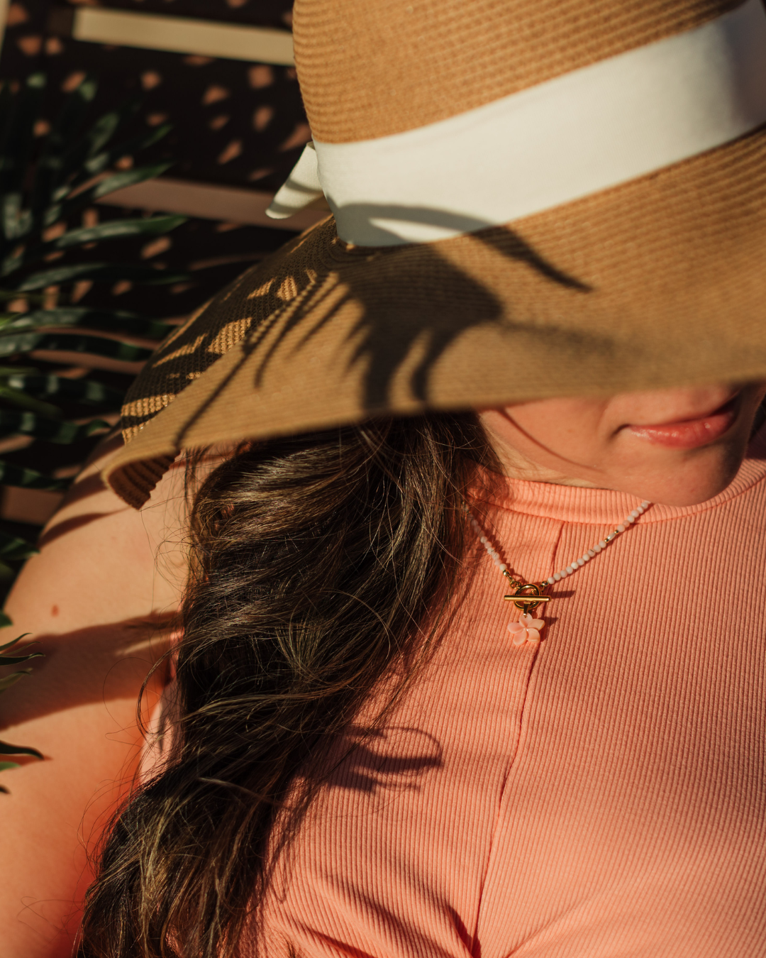 Island Blush Necklace layered with gold jewelry – Charlotte’s Cove Island Dreams Collection.