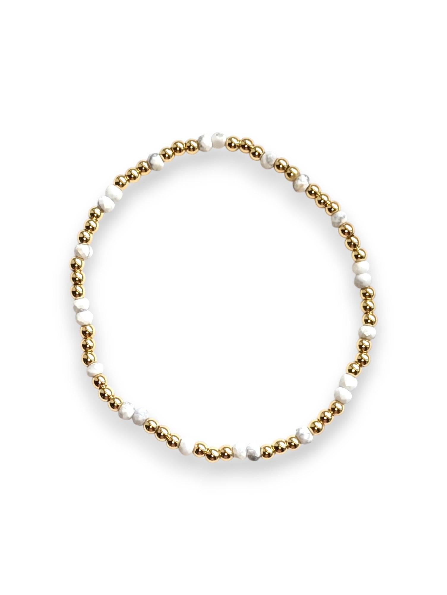 Close-up of white Howlite and gold-filled beaded stretch bracelet by Cappa Creations, handcrafted coastal jewelry.