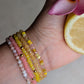 Close-up of Citrus Bloom gemstone bracelet stack with pink opal and citrine beads
