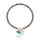 Hand-strung sea sediment jasper gemstone necklace featuring marbled berry, turquoise, and sandy neutral tones with a gold carabiner clasp and removable coastal-inspired charms.
