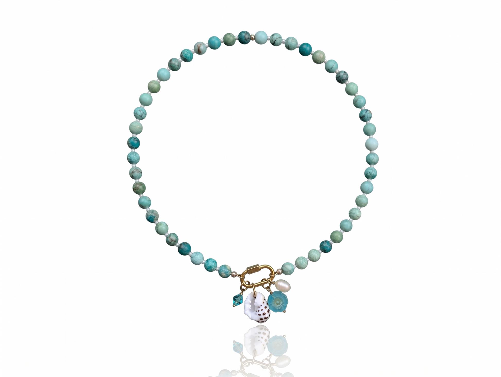 Hand-strung Peruvian turquoise gemstone necklace featuring an 18K Gold PVD oval carabiner clasp with removable charms including a turquoise Swarovski crystal, Czech glass hibiscus, Hawaiian spotted drupe shell, and freshwater pearl.