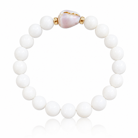 Lavender Bloom Bracelet featuring genuine polished white shell beads, a rare natural lavender cone shell centerpiece, and 14K gold-filled accent beads inspired by Hawaii's hidden beach treasures.