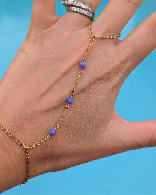 Close-up of deep plum fire opals reflecting electric blue, indigo, and violet color