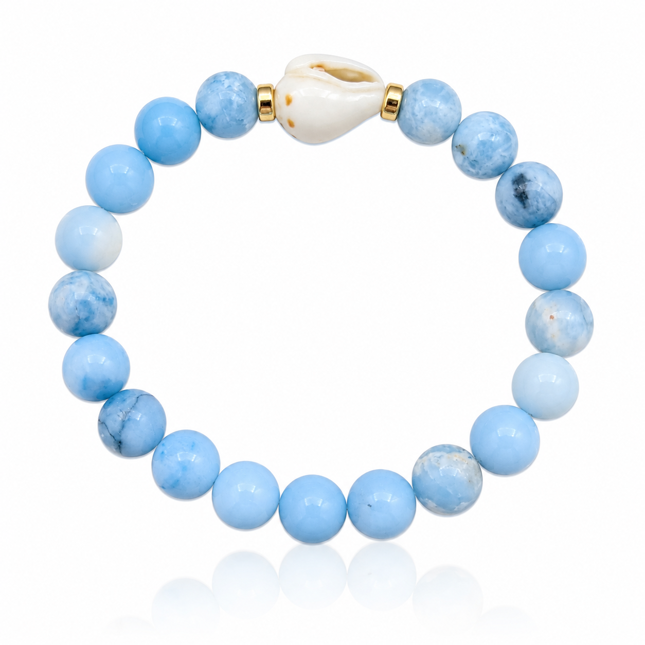 Salt Water Sky Bracelet featuring genuine Larimar gemstones, a white spotted Hawaiian conch shell centerpiece, and 14K gold-filled accent beads inspired by tropical ocean waters and blue island skies.