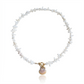 Hand-strung necklace featuring genuine coral chips, freshwater pearl accents, an authentic Hawaiian sunrise shell pendant, and an 18K Gold PVD toggle clasp inspired by the colors of Hawaiian sunrises.