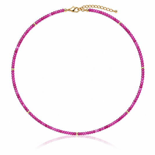 Hand-strung genuine faceted pink ruby gemstone necklace with 18K Gold PVD accents, inspired by the soft pink and purple colors of Hawaiian sunsets.